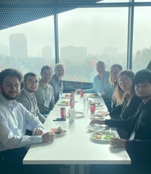 Dinner event with 8 attendees of the workshop sitting at a restaurant table in Toronto